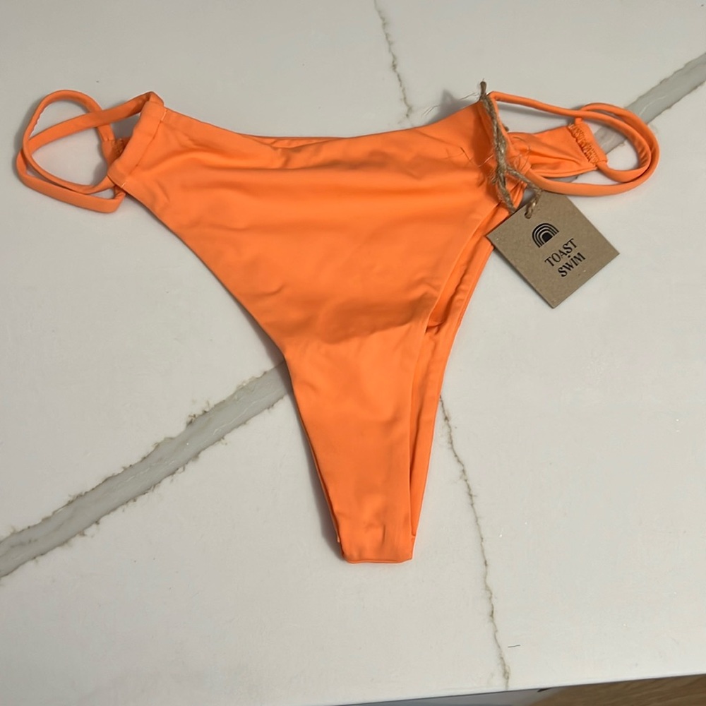 FREE PEOPLE x TOAST SWIM Signature Twist bottom. Color: Nectarine